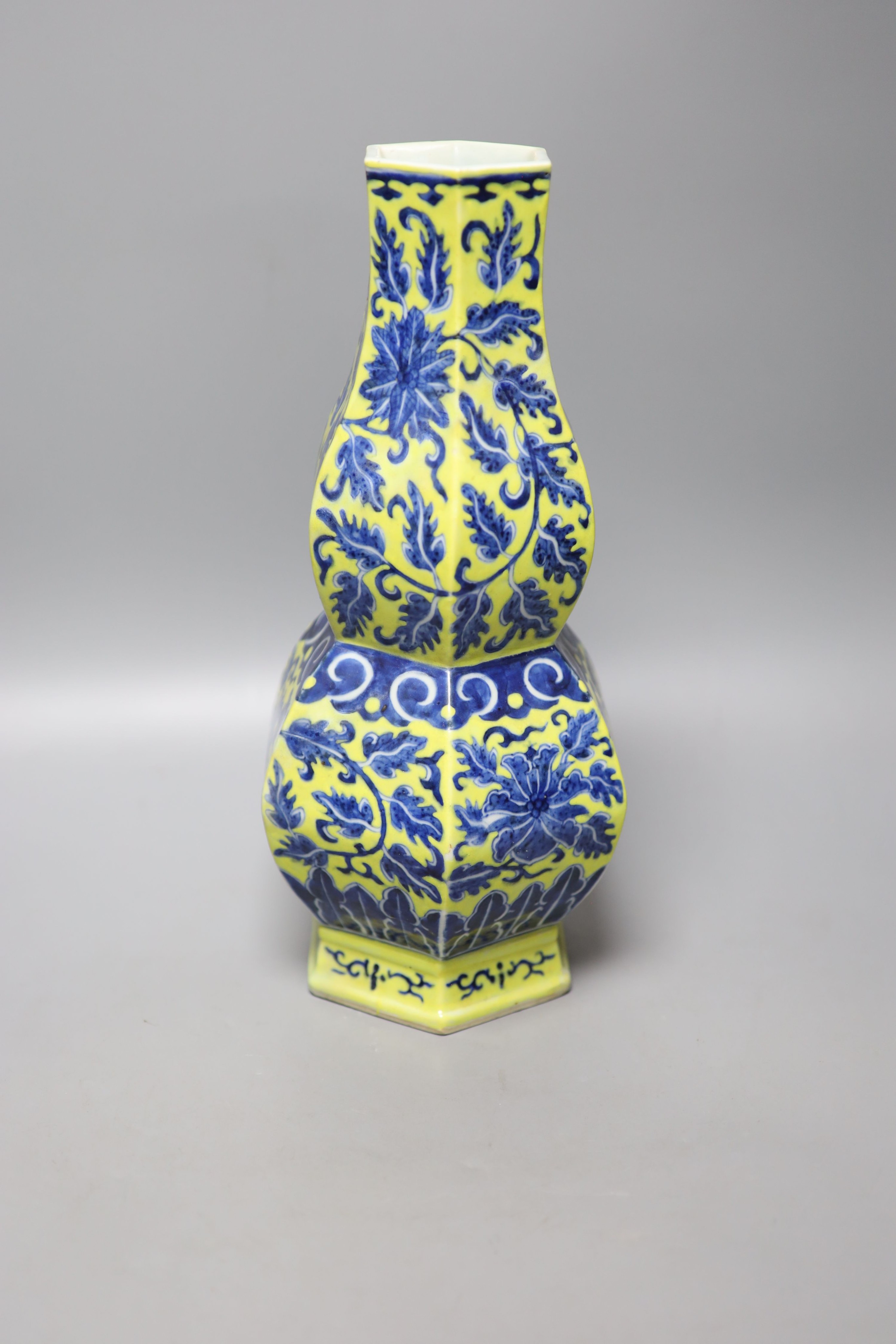 A Chinese underglaze blue yellow ground hexagonal vase, early 20th century, some restoration 35cm